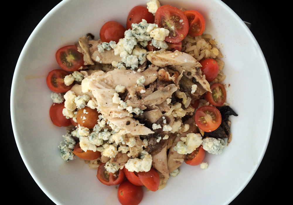 roasted chicken over rice with tomatoes and blue cheese